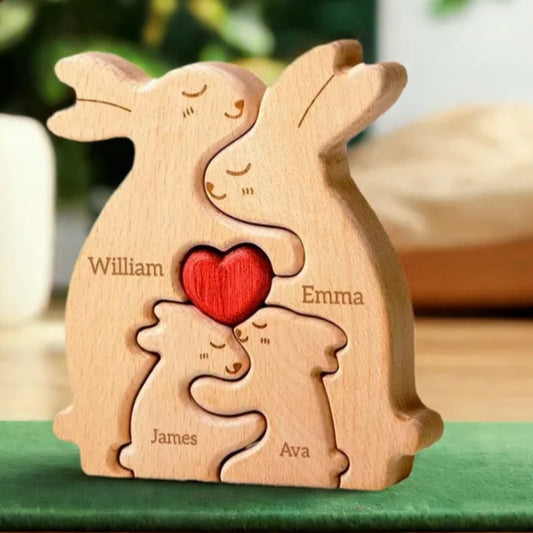 Wooden rabbit family puzzle with engraved names on a green surface