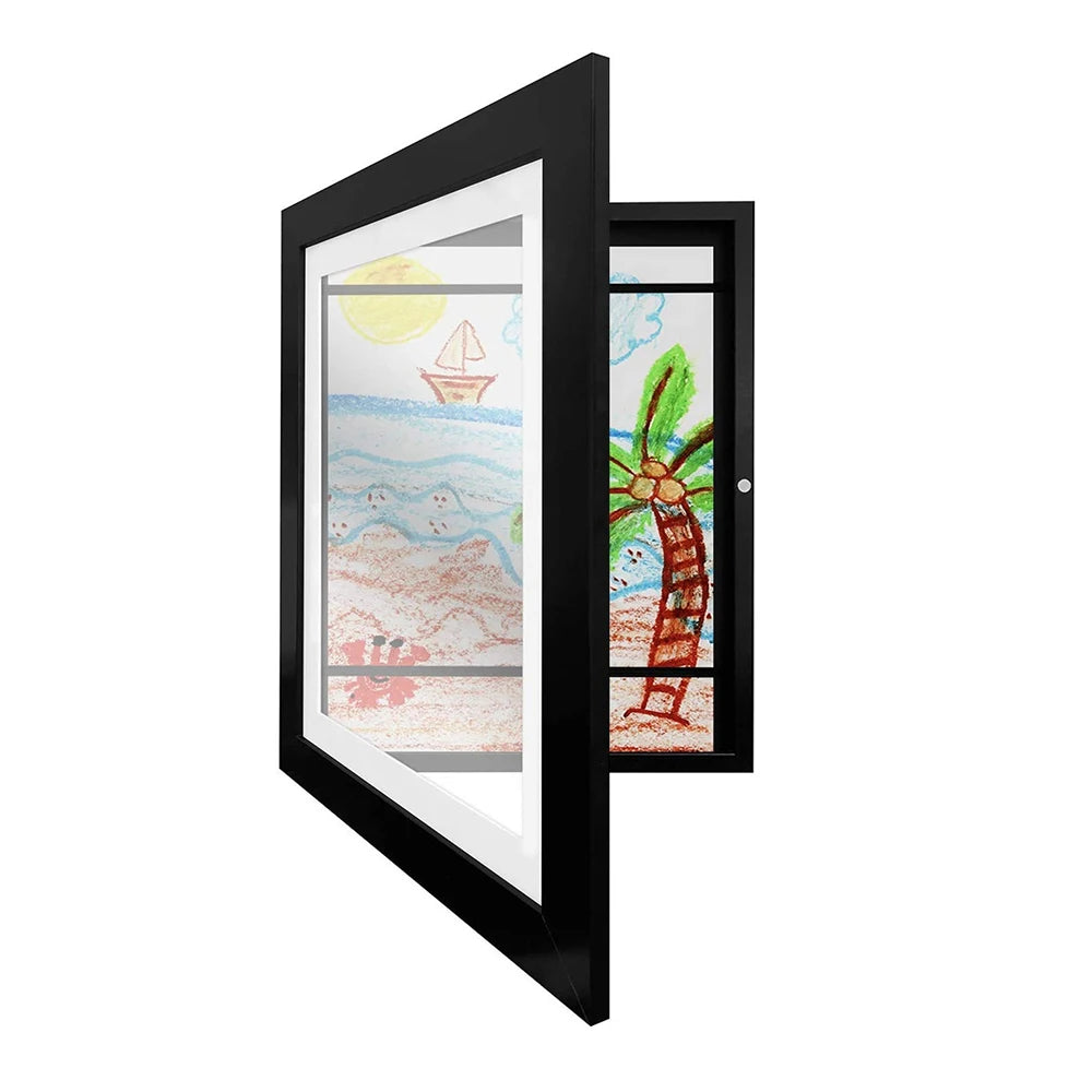 Black picture frame with two children's drawings inside, one of a beach scene and the other of a palm tree.