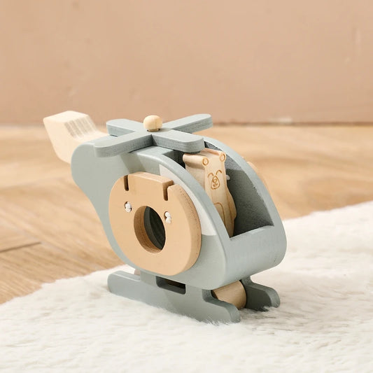 Wooden toy helicopter on a soft surface with a neutral background