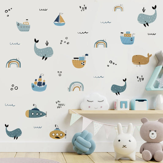 Children's room with decorative wall stickers of whales, boats, and rainbows.