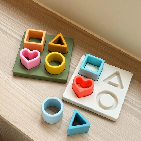 Colorful geometric shapes and letter blocks on a wooden surface