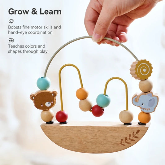 Wooden baby toy with colorful beads and animal figures, held by a hand.